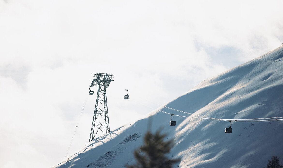 Chairlifts run across a snowy mountain slope in the Zell am See ski area.
