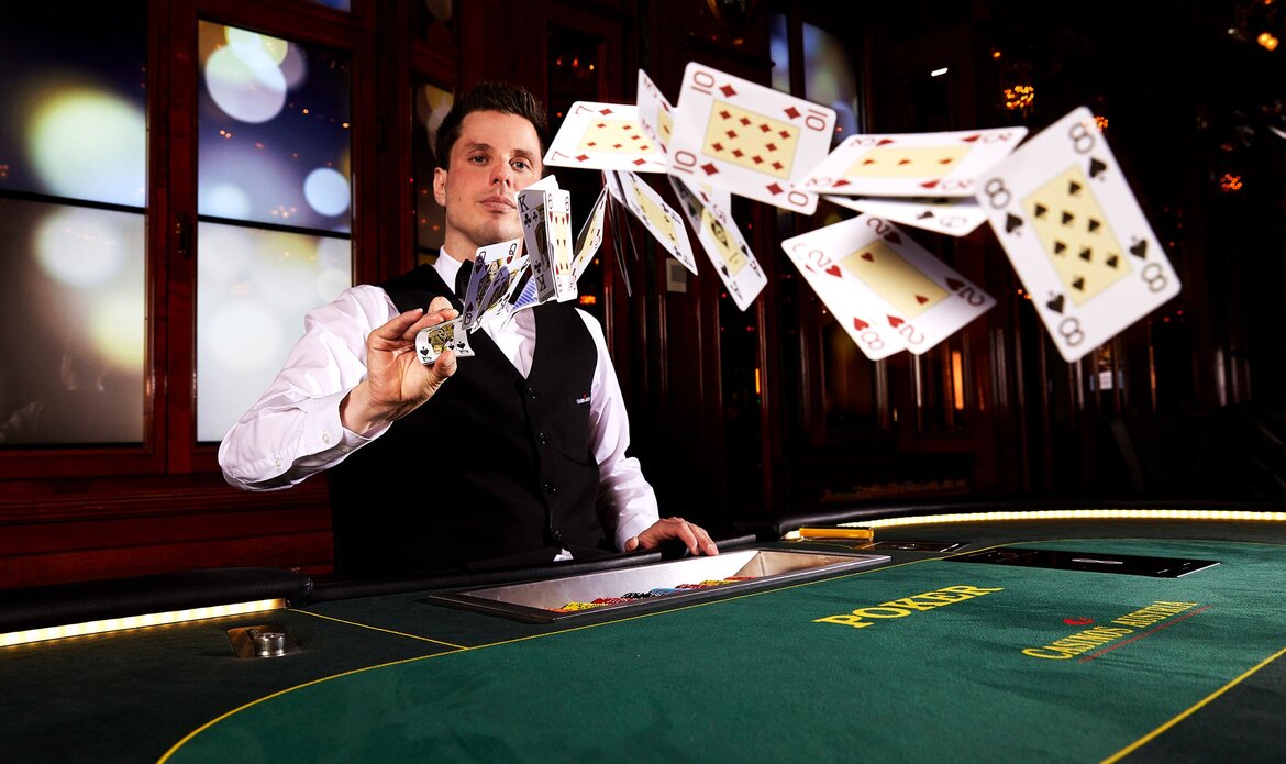 A croupier is dealing playing cards at a green casino table in Zell am See.