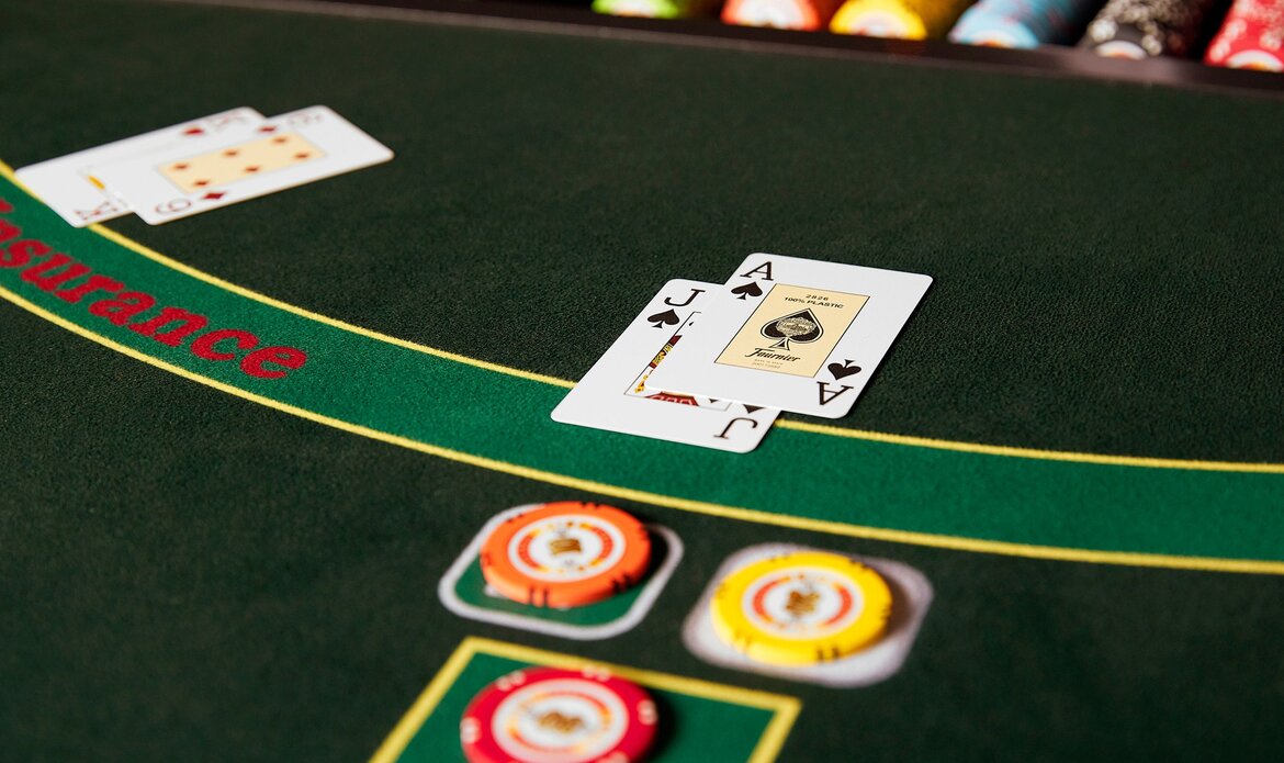 Playing cards and chips lie on a green casino table.